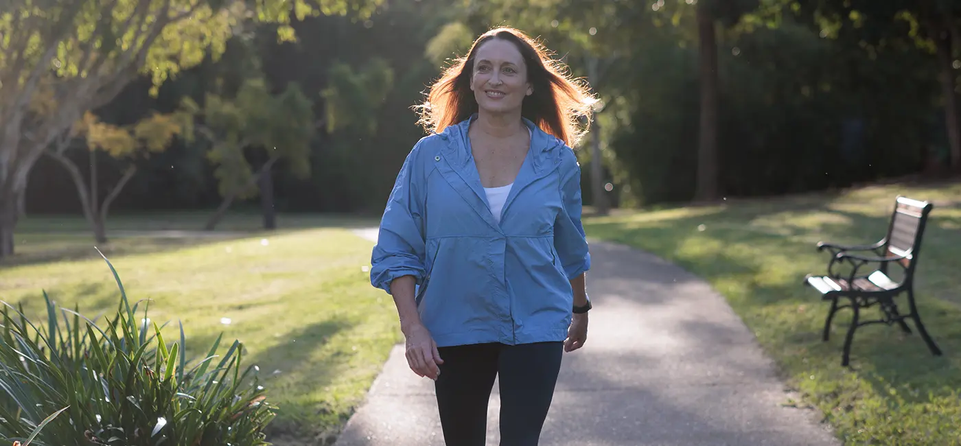 Image of Georgie outside walking towards the camera smiling