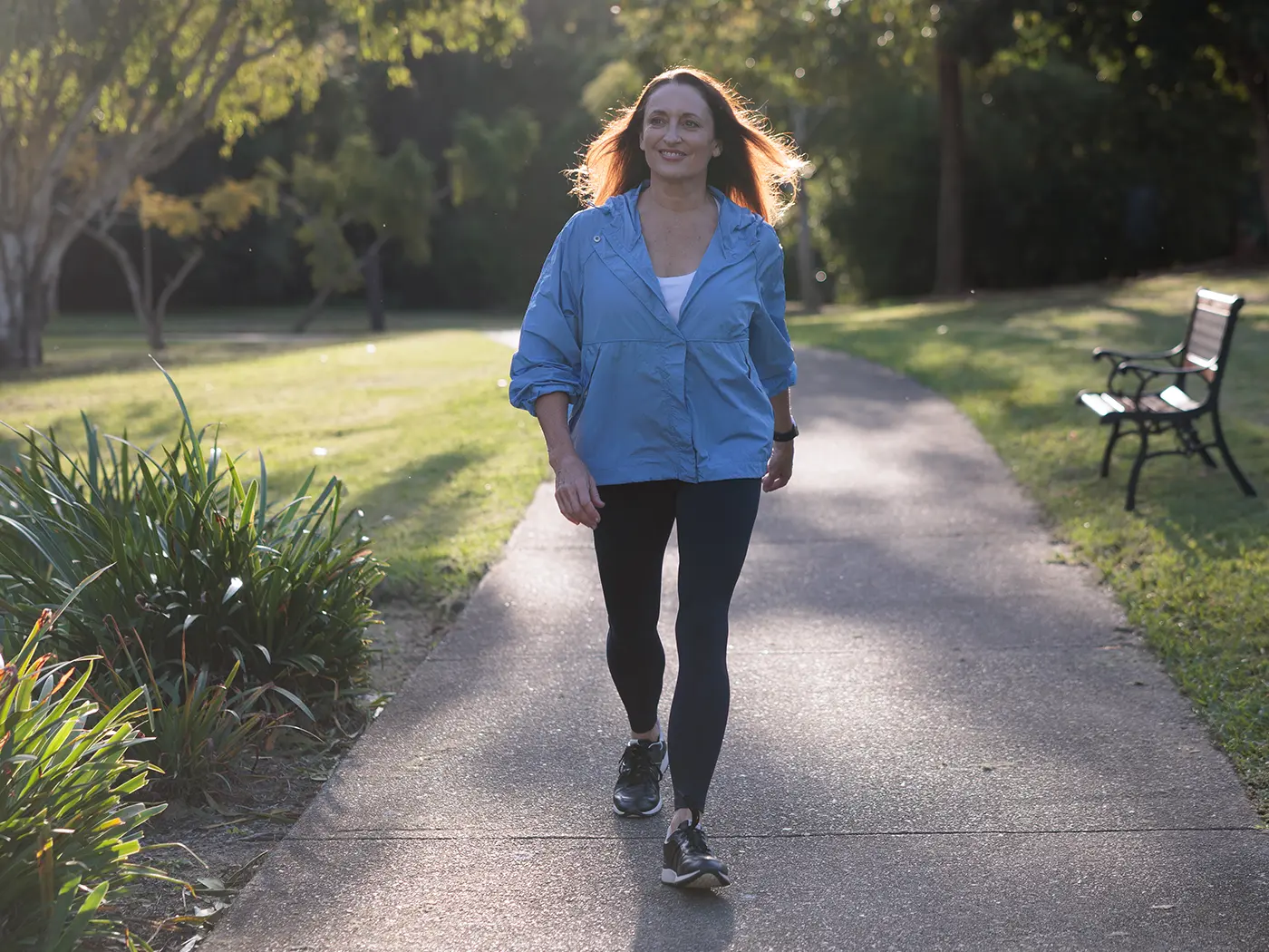 Image of Georgie outside walking towards the camera smiling