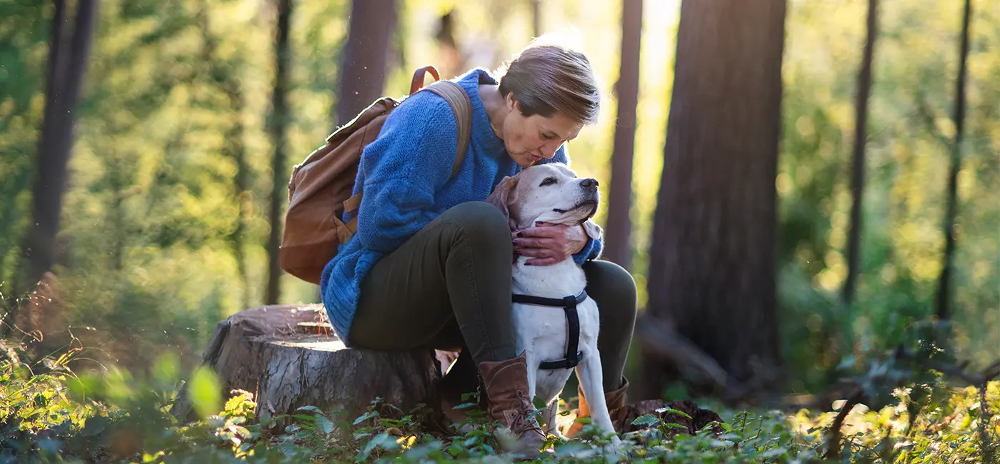 Woman outside sitting with her dog