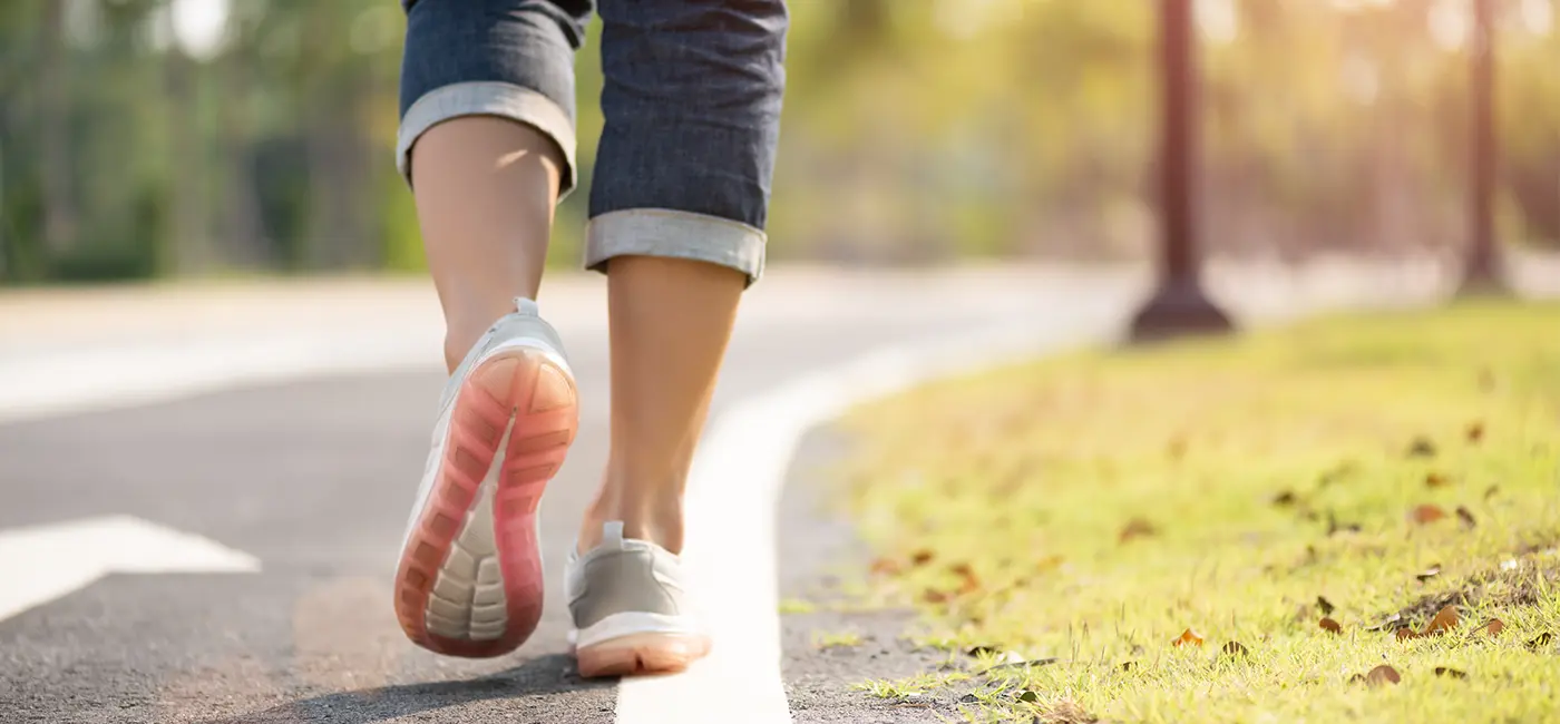 Close-up of a woman walking along the side of a path