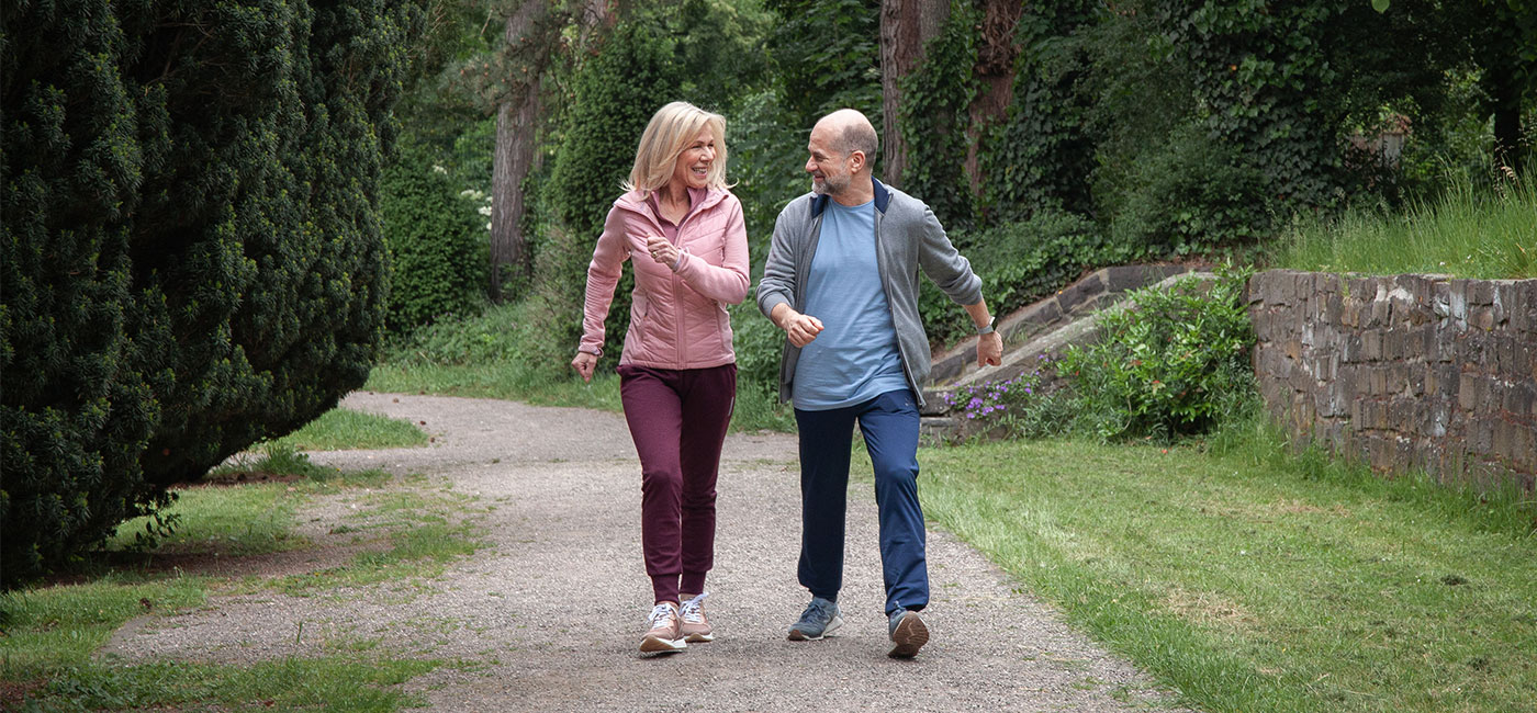 Ulrike and her friend walking outside along a path