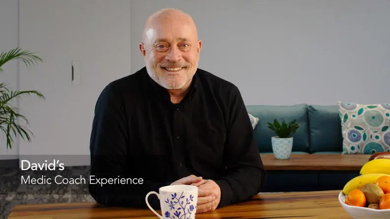 David, a happy customer, smiling sitting in his living room