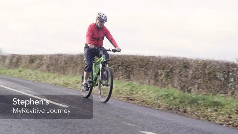 Image of Stephen riding his bike on the road through the country side